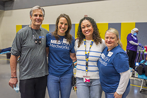 A man and 3 women working event