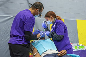 2 people working on a patient